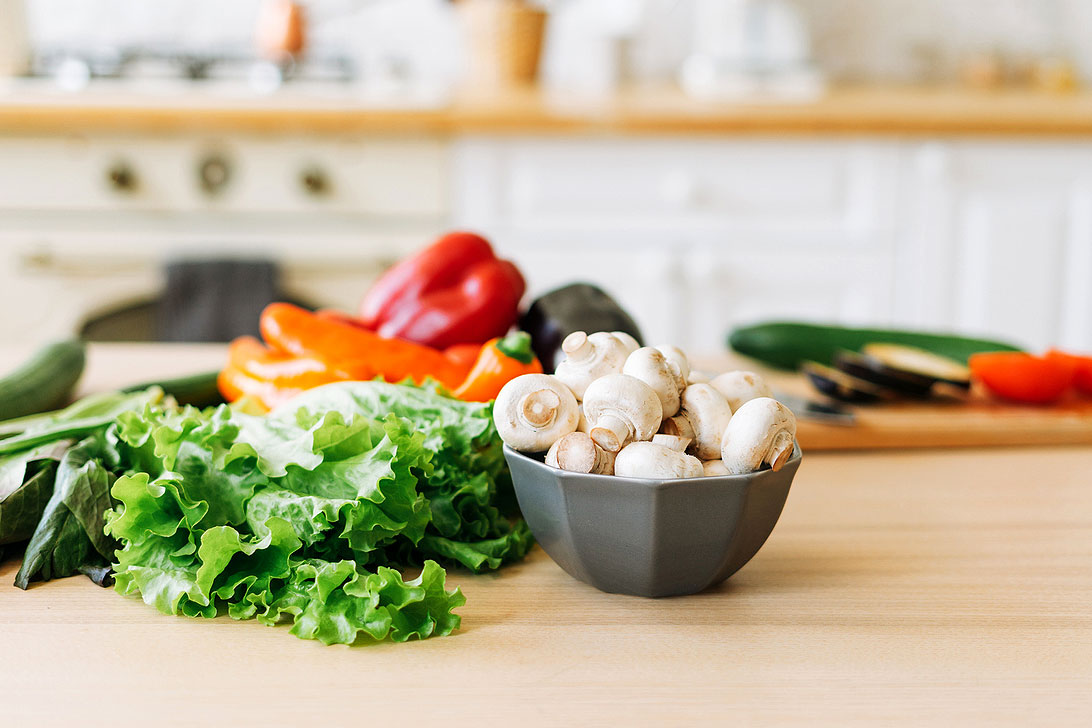 An image of vegetables on a wooden countertop