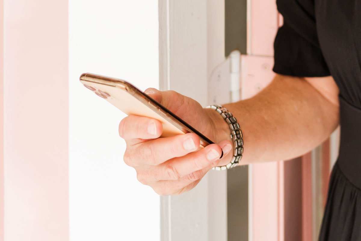 A close-up image of a hand holding a phone