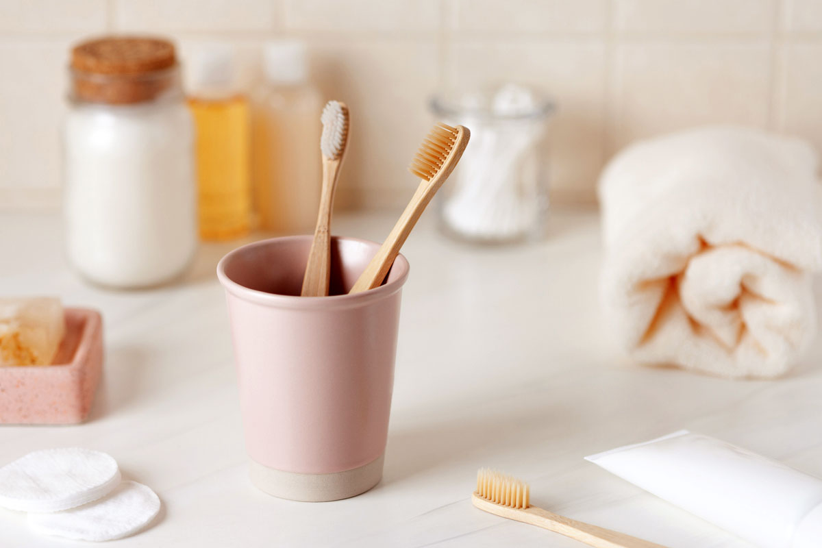 An image of toothbrushes, toothpaste, and other bathroom accessories