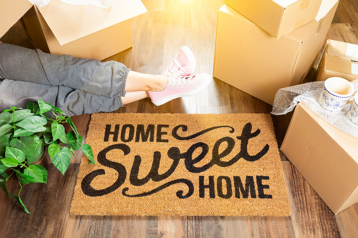 An image of a doormat that says "home sweet home"
