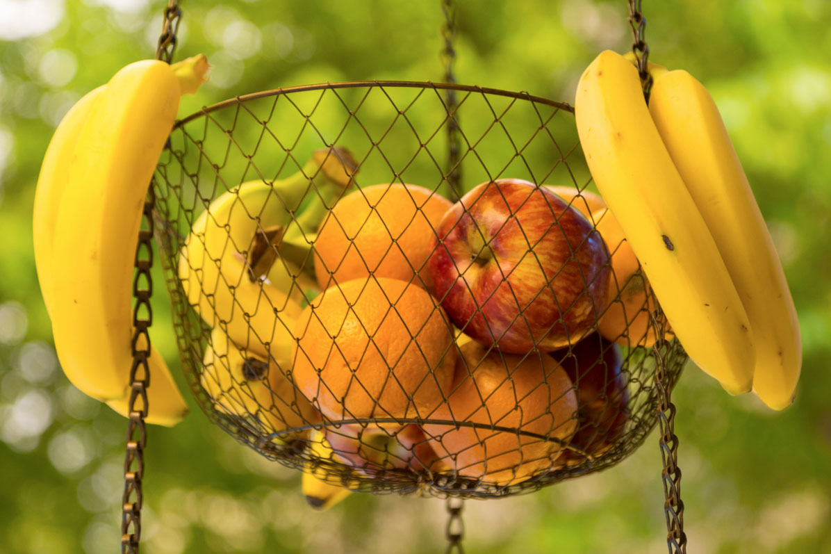 An image of fruit in a hanging basket