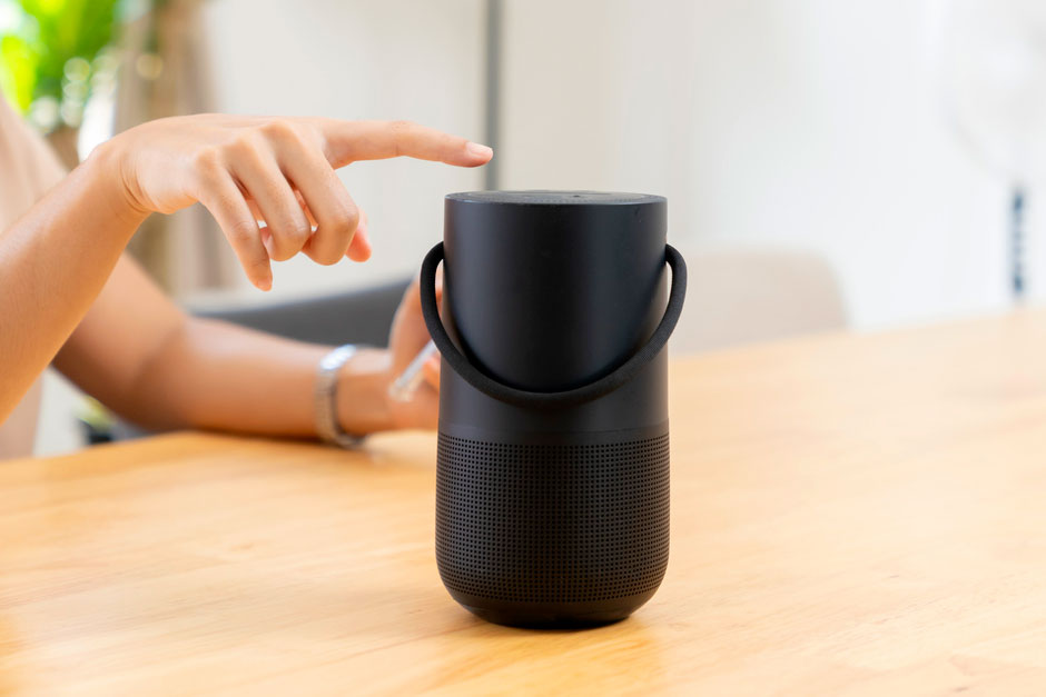 An image of a smart speaker on a wooden table