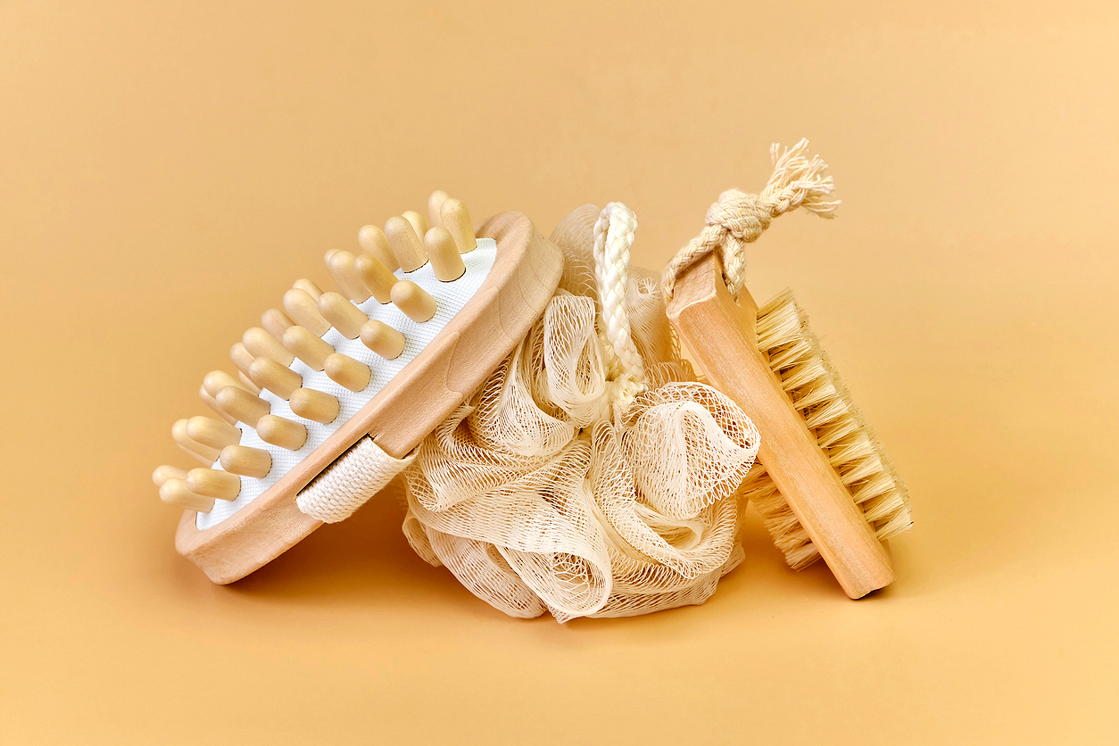 An image of a loofah and two body brushes