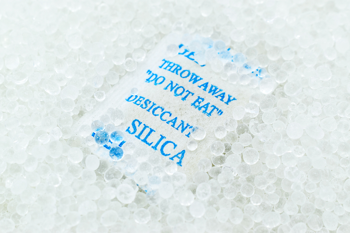 Silica packet with blue writing that reads "Throw away do not eat"