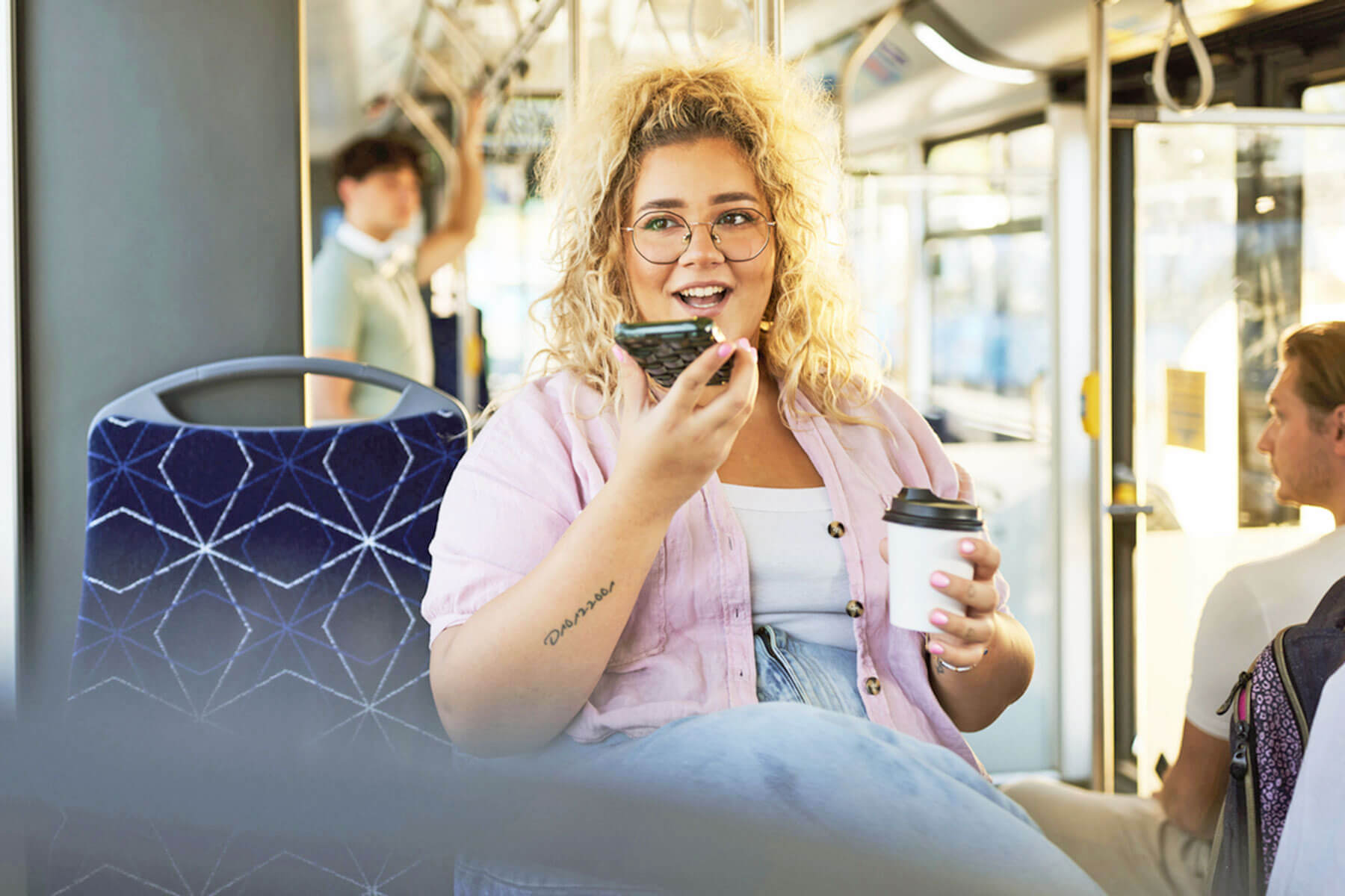 Woman on speakerphone at a coffee shop