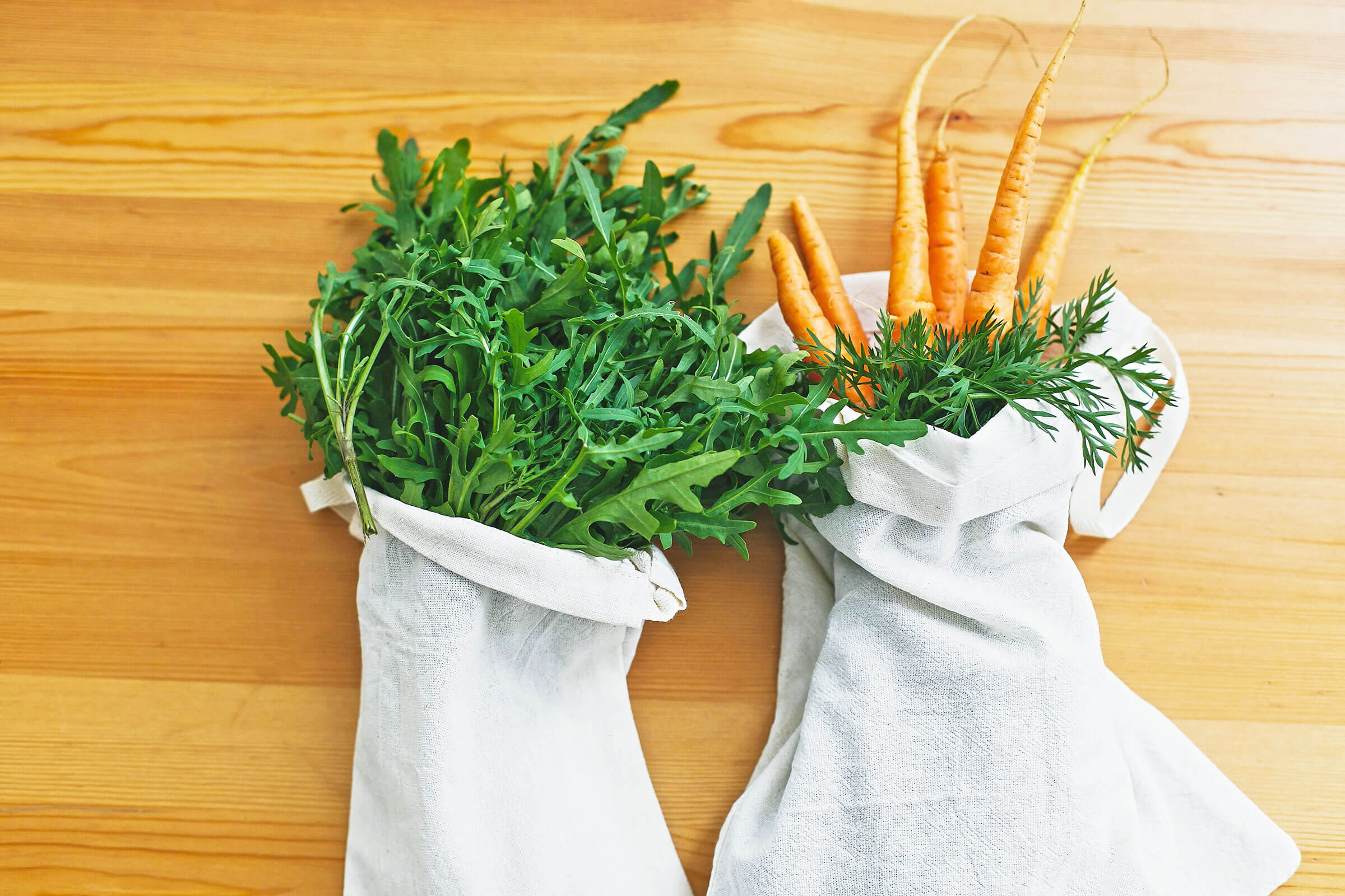 Two mesh bags full of produce