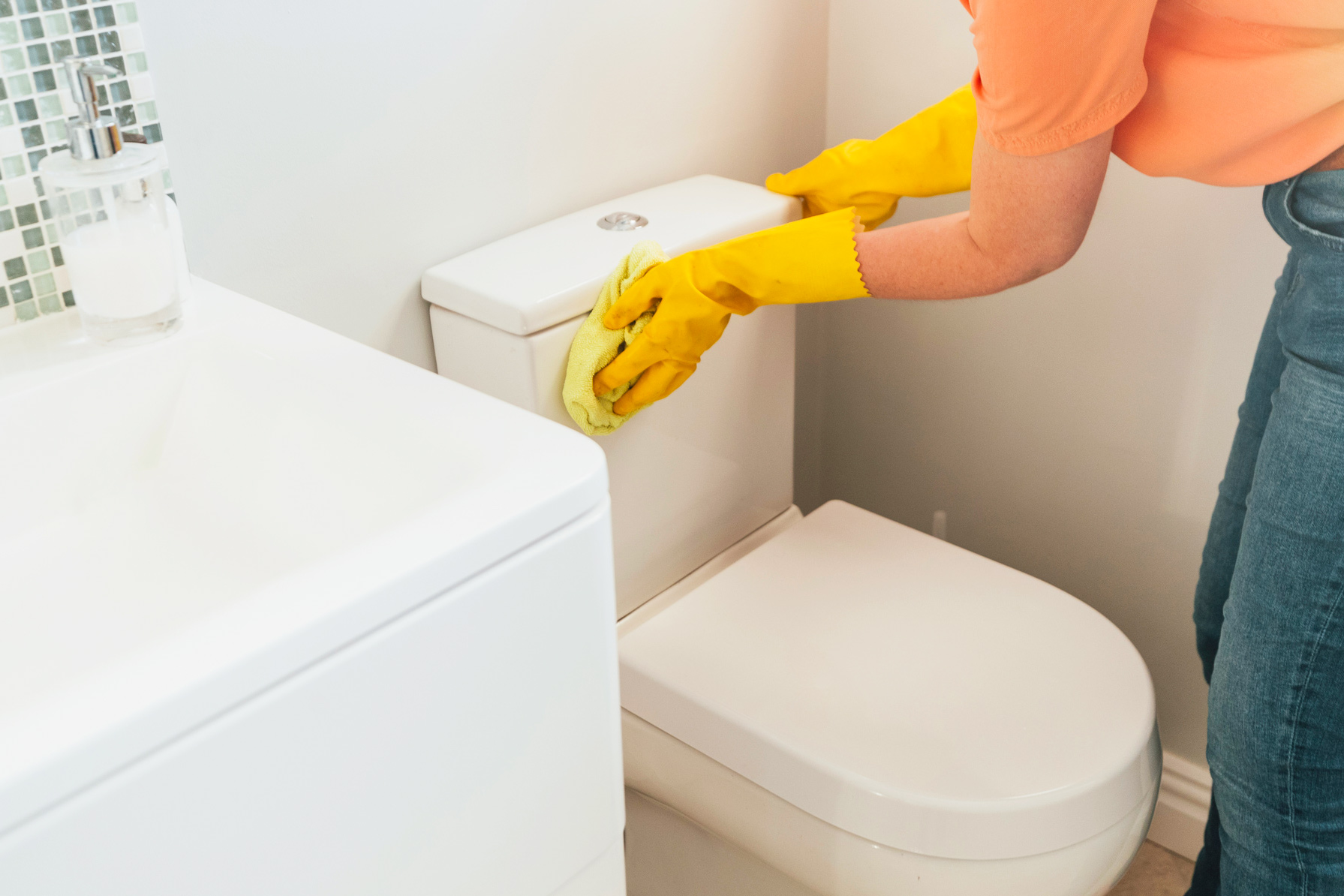 Person scrubbing toilet
