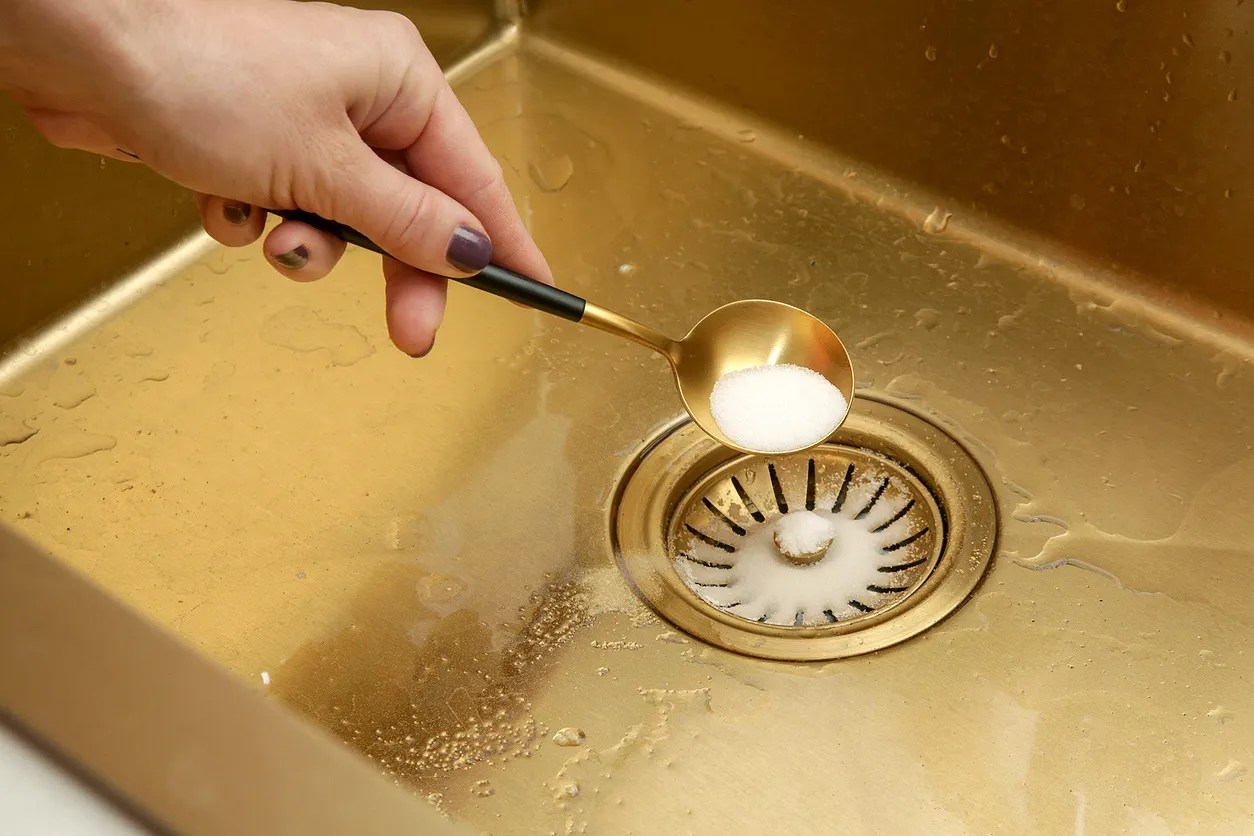 Pouring salt down a kitchen sink 