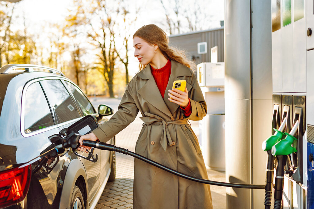 Woman filling up her gas tank