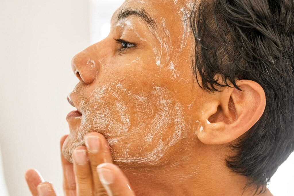 Person exfoliating face