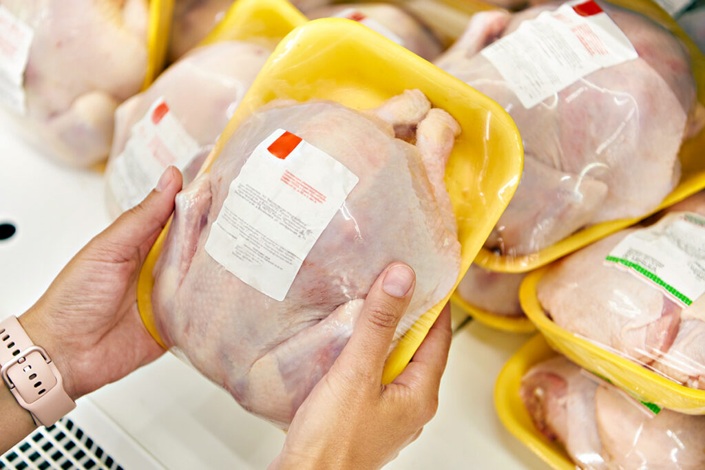 Whole chicken in packaging at grocery store