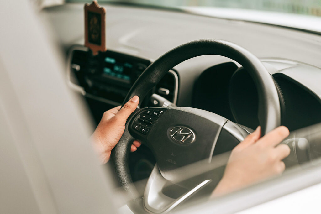 Hands on a steering wheel