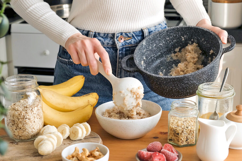 Person scooping oats into a bowl