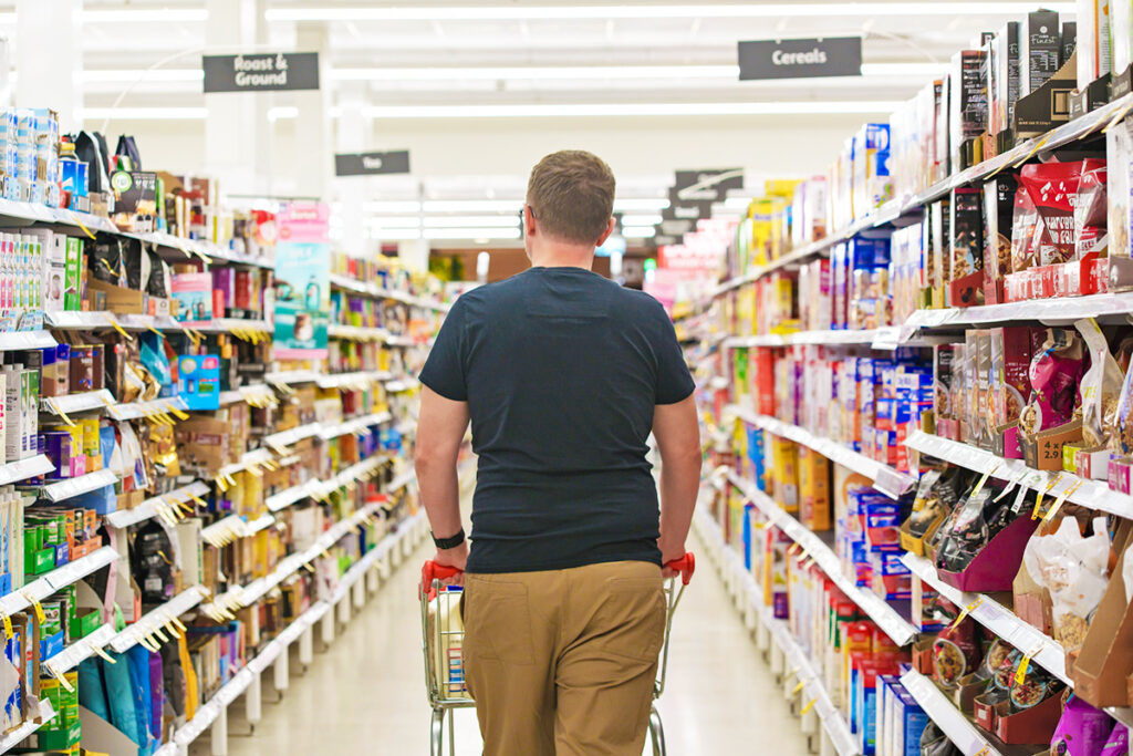 Man walking down grocery store aisle