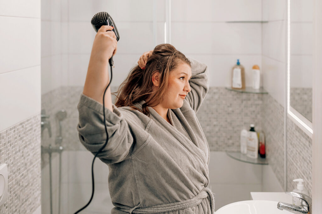 Woman blow drying hair