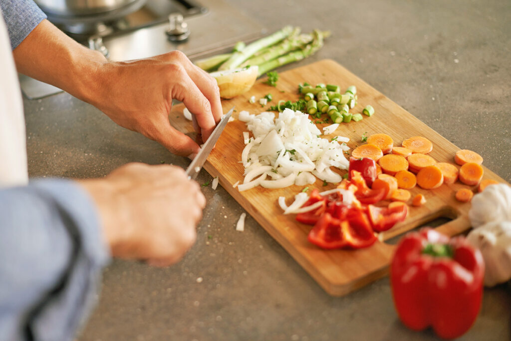 Chopping vegetables on cutting board