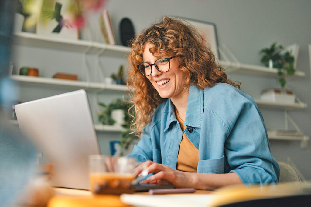 Woman on laptop smiling