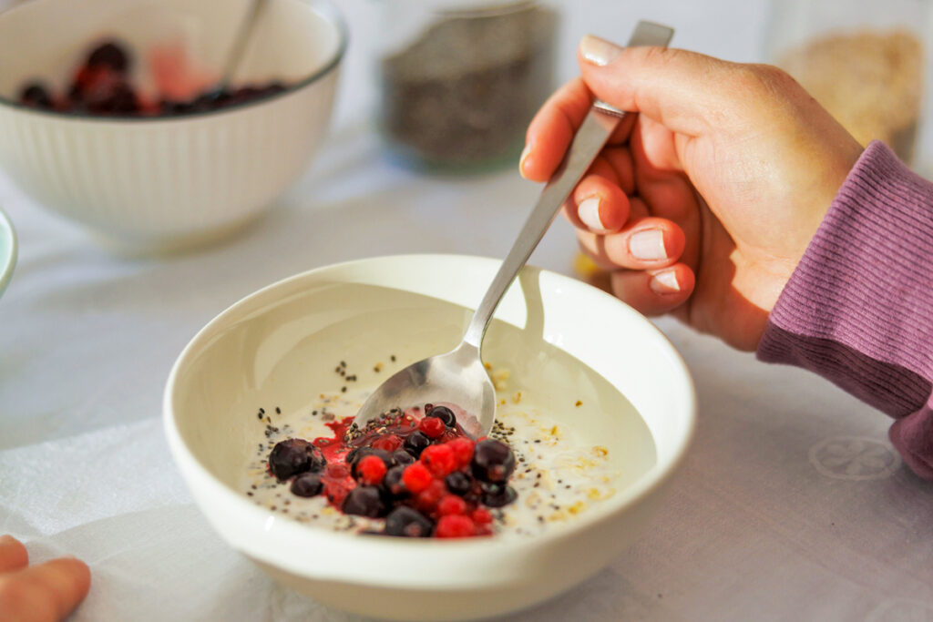 Woman eating yogurt with fruit
