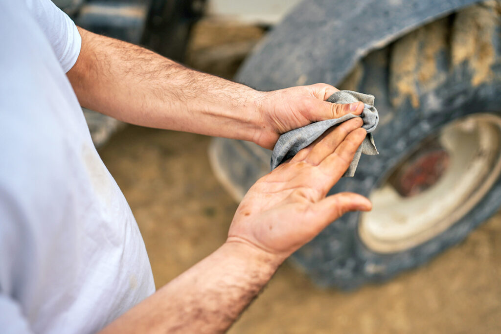 Person wiping off dirty hands
