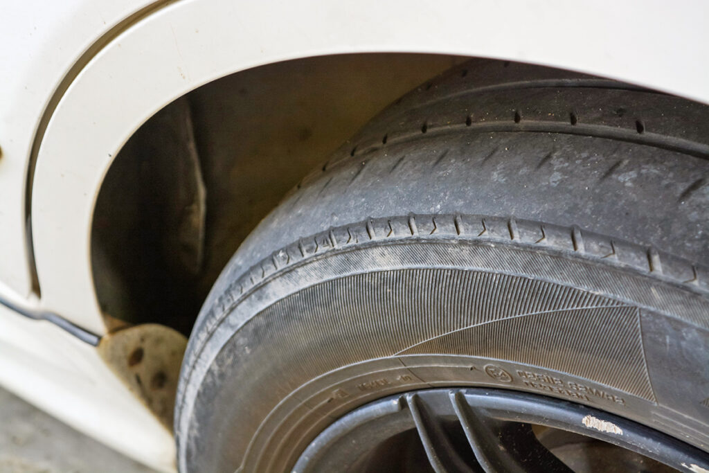 Closeup of a tire with worn treads