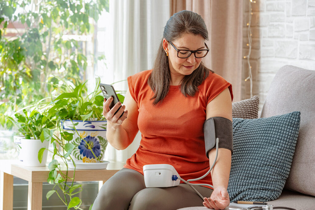 Woman taking blood pressure at home