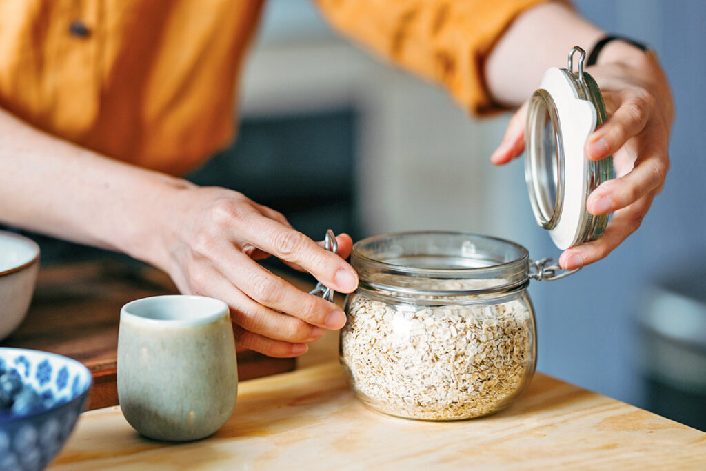 Person opening jar of oats