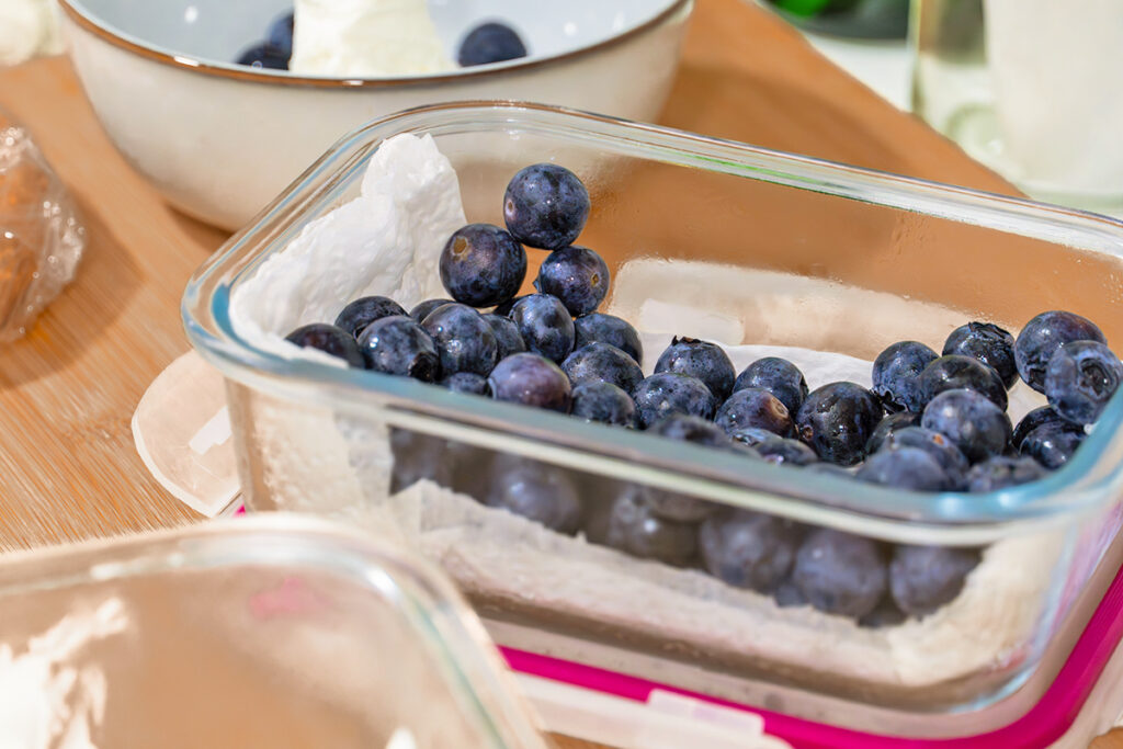 Blueberries in a container with a paper towel