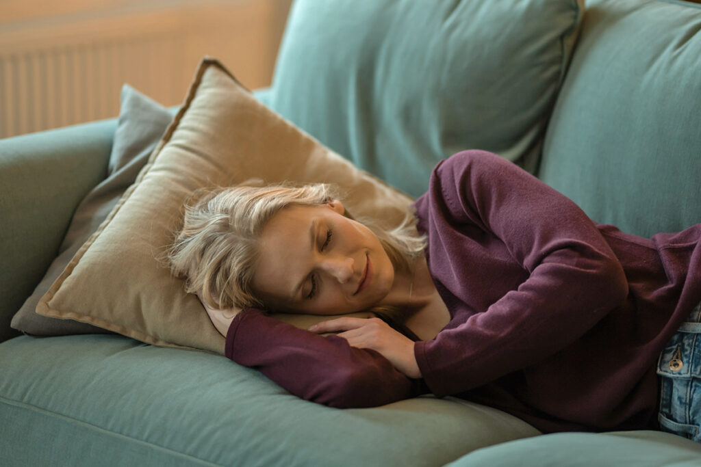 Woman napping peacefully on couch