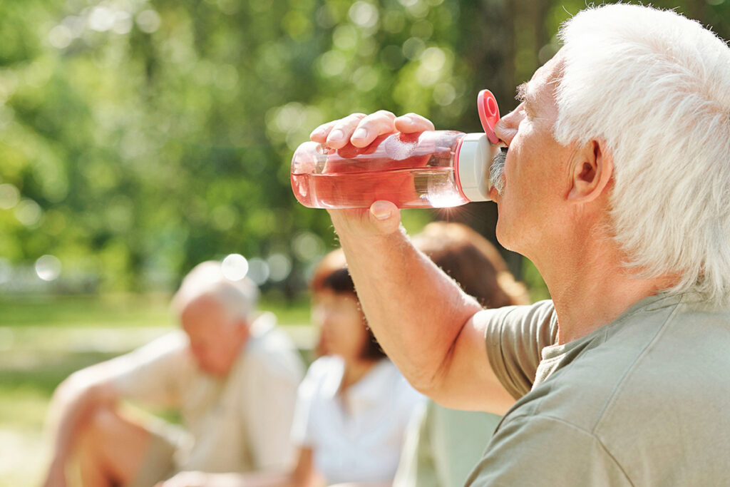 Older man drinking water