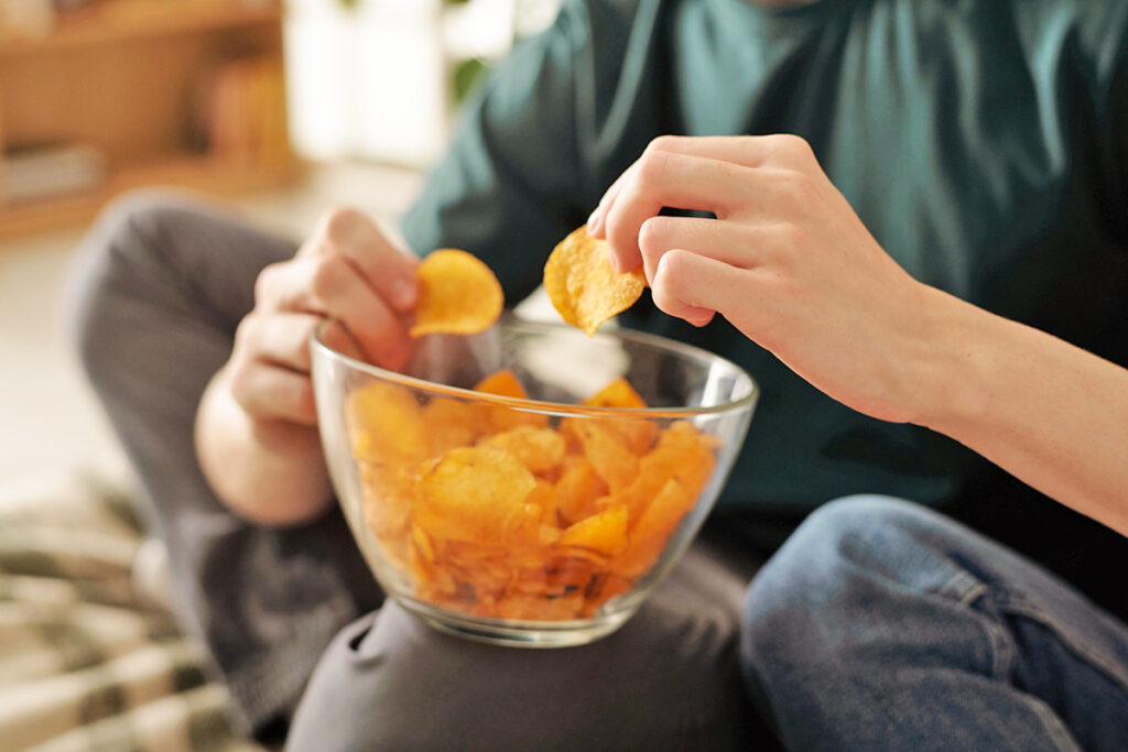 Person eating potato chips