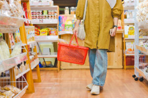 Woman holding red shopping basket