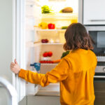 Woman opening fridge