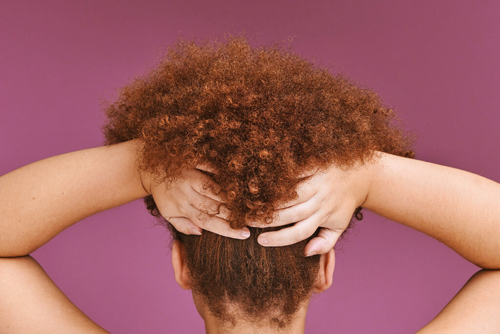 Woman holding up curly hair