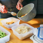 Putting leftovers in food storage containers