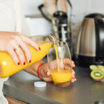 Woman pouring orange juice